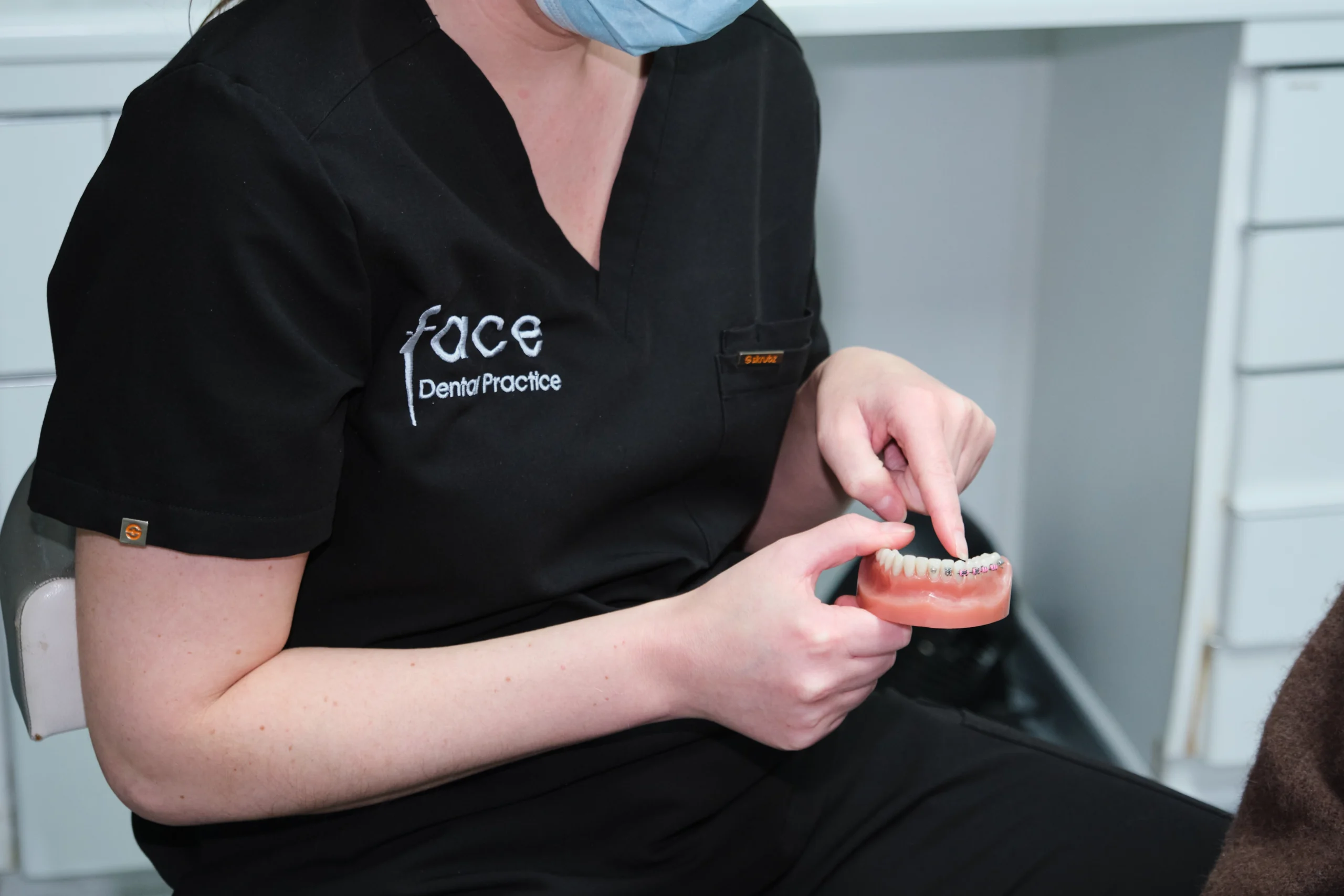 Orthodontist website design by AlignMedia, shown during a patient consultation at an orthodontic practice